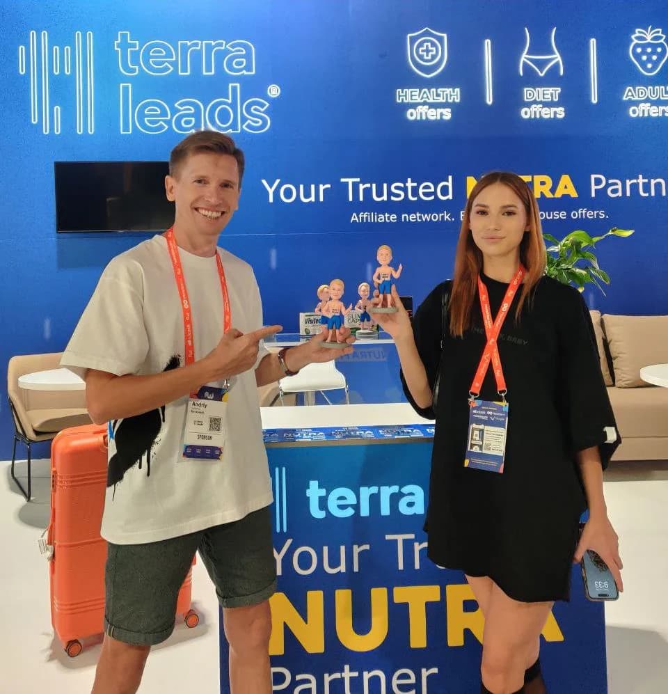 Andrew Sakhno and a colleague with conference badges at the TerraLeads stand